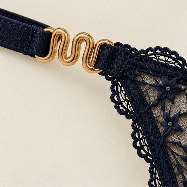 The serpent clasp closing the thong at the hip.